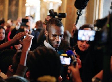 Lassana Bathily talks with children at the Paris city hall just over a week after the attack.