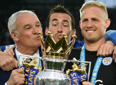Claudio Ranieri, Christian Fuchs and Kasper Schmeichel celebrate with the Premier League trophy.