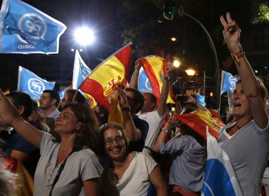 Followers of Spain's Popular Party celebrate the results of their party at the national elections in Madrid yesterday.