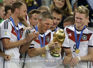 Germany's Bastian Schweinsteiger prepares to lift the World Cup.