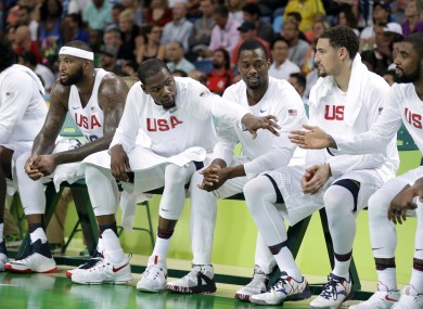 nited States' Kevin Durant, left, reacts with teammates on the bench during a quarterfinal round basketball game against Argentina.