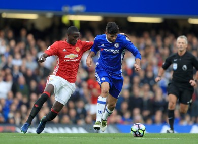 Eric Bailly battles for possession with Diego Costa at Stamford Bridge.