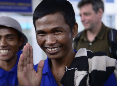 Sailors who had been held hostage by pirates for more than four years, smile as they arrive at the airport in Nairobi, Kenya.