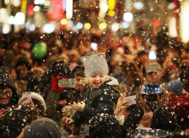 Freya Warton (4) from Greek Street, Dublin sits on her mother's shoulders as the Christmas Lights are switched on on Henry Street.