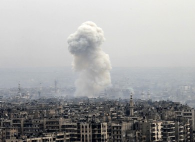 Smoke rises following an air strike on insurgents positions in eastern Aleppo on Monday,