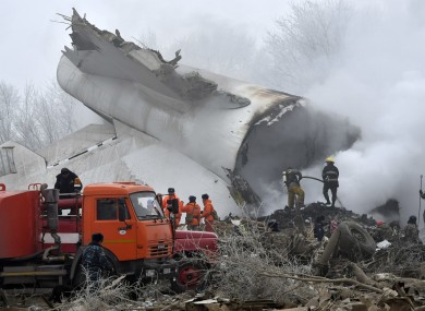 Kyrgyz Emergency Ministry officials work among remains of a crashed Turkish Boeing 747 cargo plane