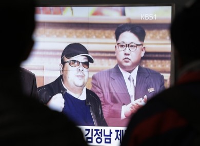 A TV screen shows pictures of North Korean leader Kim Jong Un and his older brother Kim Jong Nam.