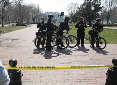 US Secret Service officers stand in the cordoned off area on Pennsylvania Avenue after a security incident near the fence of the White House in Washington yesterday.