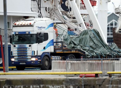A flatbed truck carrying the wreckage of Rescue 116.
