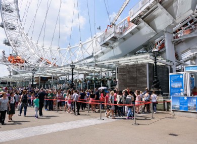 Visitors queue up to ride on the London Eye as security is stepped up