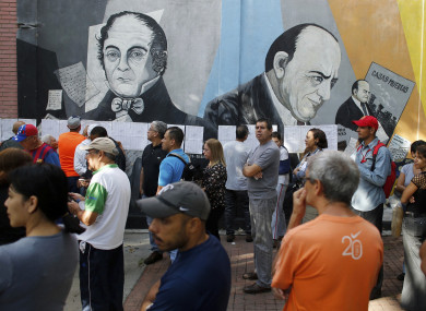 People lineup to enter to a poll station during the election for a constitutional assembly in Caracas, Venezuela