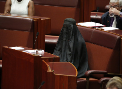 Senator Pauline Hanson wears a burqa during question time in the Senate chamber at Parliament House in Canberra, Australia.