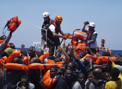 File photo of rescuers of SOS Mediterranée distributing lifejackets to migrants in distress on the Mediterranean Sea.