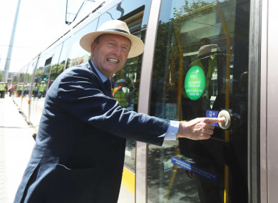 Pictured is Minister for Transport Shane Ross wearing a Bloomsday hat and about to step onto a Luas.