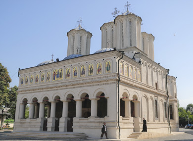 A priest walks outside the Romanian Patriarchal Cathedral in Bucharest.