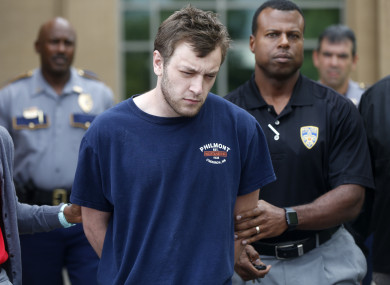 Kenneth James Gleason is escorted by police to a waiting police car in Baton Rouge.