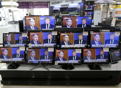 TV screens show Donald Trump and Kim Jong-un in Seoul, South Korea.