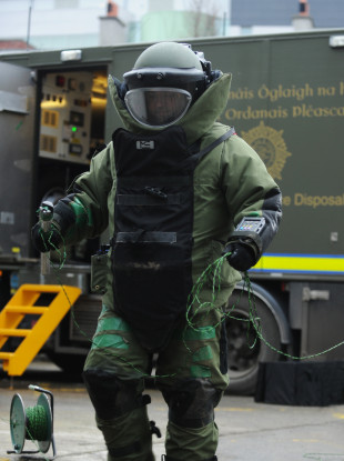 An Army Bomb Disposal member makes an approach to an explosive device