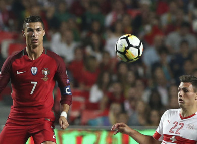 Portugal's Cristiano Ronaldo, left, challenges for the ball with Switzerland's Fabian Schar.