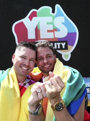 Scott D'Amico and Brad Harker celebrate after the same sex marriage vote result announcement in Queens Park, Brisbane Australia