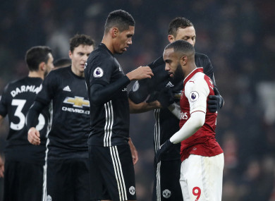 Chris Smalling shake hands with Arsenal striker Alexandre Lacazette.