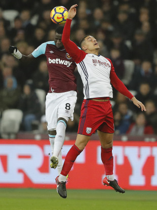 West Brom's Jake Livermore challenging for a header with West Ham's Cheikhou Kouyate.