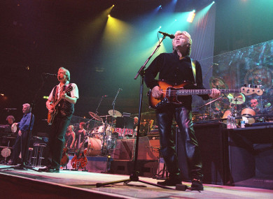 Ray Thomas performing alongside band members Justin Hayward and John Lodge.