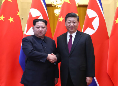North Korea and China's leaders shake hands at the official meeting.