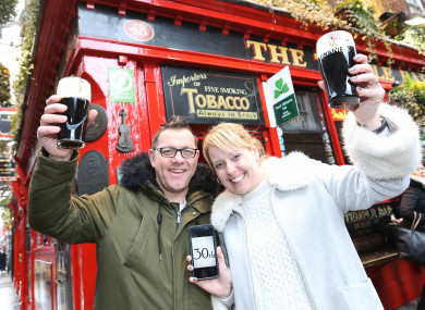 Jenna and Mark Durrant from England raising a pint outside the Temple Bar pub.