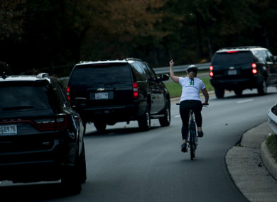 Juli Briskman gestures with her middle finger as a motorcade with US President Donald Trump departs Trump National Golf Course last October.