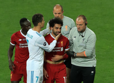 Real Madrid's Cristiano Ronaldo consoles Liverpool's Mohamed Salah as he leaves the pitch injured.