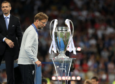Liverpool manager Jurgen Klopp walks dejected past the trophy after the UEFA Champions League Final.