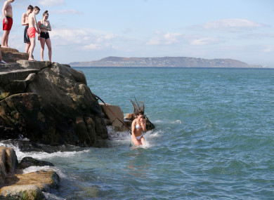People jump into the water at the 40 Foot in Dublin.