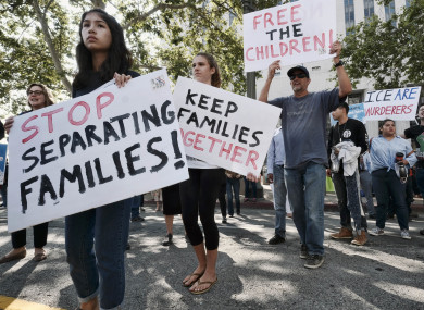 Protestors carry signs and chant slogans in front of Federal Courthouse in Los Angeles