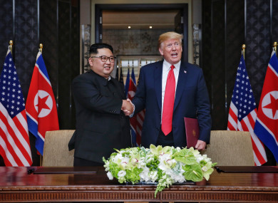 Top leader of the Democratic People's Republic of Korea (DPRK) Kim Jong Un (L) shakes hands with US President Donald Trump