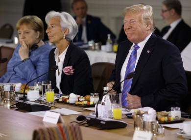 Trump next to Angela Merkel and Christine Lagarde at the summit today.