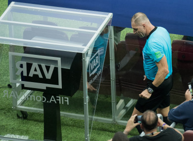 Referee Nestor Pitana walks to the VAR Monitor during the World Cup final.