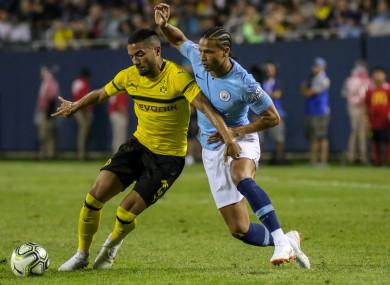 Manchester City midfielder Leroy Sane (19) battles Borussia Dortmund defender Jeremy Toljan.