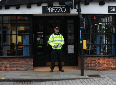 A police officer outside the Prezzo restaurant in Salisbury, where a couple had become unwell after exposure to an unknown substance.