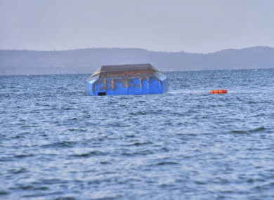 The upturned passenger ferry MV Nyerere floats in the water near Ukara Island in Lake Victoria.