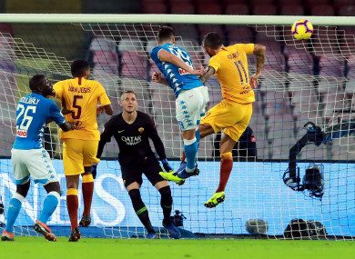 Arkadiusz Milik sends a header at goal for Napoli.