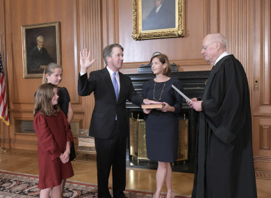 Retired Justice Anthony M. Kennedy, right, administers the Judicial Oath to Judge Brett Kavanaugh in the Justices' Conference Room of the Supreme Court Building
