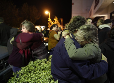 Eva Mills, right, and Holden Grzywacz, two survivors of the Las Vegas mass shooting, mourn the death of Sean Adler during a vigil.
