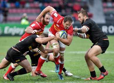 Canada captain Phil Mack breaks through a tackle.