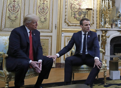 French President Emmanuel Macron touches the knee of President Donald Trump during their meeting inside the Elysee Palace in Paris.