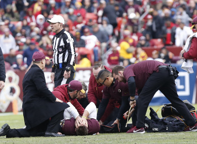 Washington quarterback Alex Smith receiving treatment last night.
