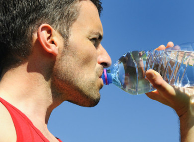 File photo of a man drinking water from a plastic bottle.