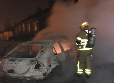Firefighter in breathing apparatus extinguishing a car fire in South Dublin on Halloween.
