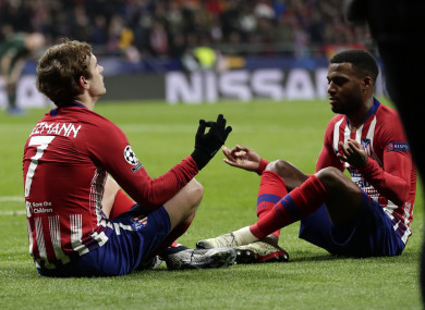Antoine Griezmann and Thomas Lemar celebrate a goal for Atletico Madrid.