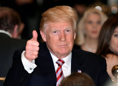 President Donald Trump gives a thumbs-up as he has Thanksgiving Day dinner at his Mar-a-Lago estate in Palm Beach, Florida on Thursday.